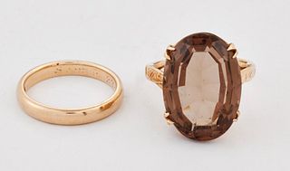 A SMOKY QUARTZ RING, an oval-cut smoky quartz in a double-claw setting to f