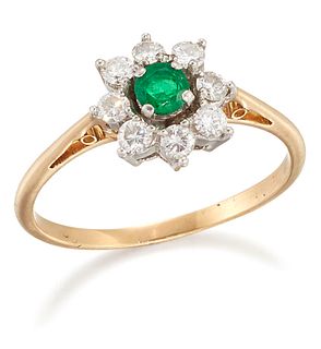AN EMERALD AND DIAMOND CLUSTER RING, a round-cut emerald within a border of