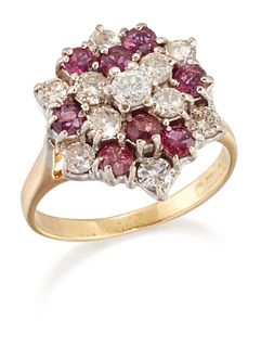 AN 18 CARAT GOLD RUBY AND DIAMOND CLUSTER RING, the tiered hexagonal head s
