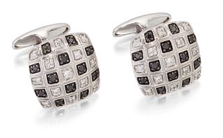 A PAIR OF DIAMOND CUFFLINKS, the cushion-shaped tops square set with black 