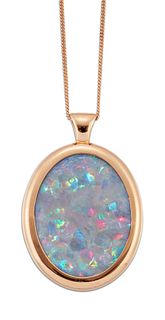 AN OPAL PENDANT ON CHAIN, a large oval opal within a plain rose coloured fr