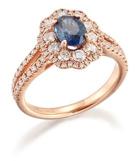 AN 18 CARAT GOLD SAPPHIRE AND DIAMOND CLUSTER RING, an oval-cut sapphire wi