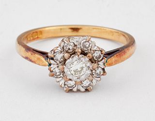 AN 18 CARAT GOLD DIAMOND CLUSTER RING, a round brilliant-cut diamond within