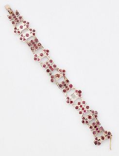 A RUBY BRACELET, x-form and bar links set with round-cut rubies. Length 14.