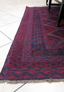 A mid 20th century Afghan burgundy ground rug, 185 x 144cm <br> <br>