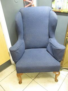 An upholstered wing back armchair <br> <br>