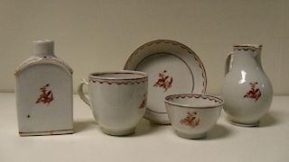 A late 18th/early 19th century child's five piece tea set, each piece painted in sepia with a flower