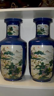 A pair of 19th century powder blue ground vases, each painted with canted rectangular and fan shaped