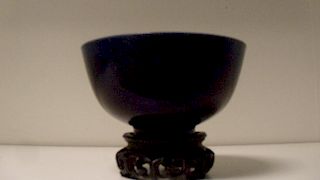 An aubergine glazed bowl incised with clouds alternating with floral rosettes on the exterior, a sin