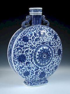 A Ming style blue and white moon flask. scroll handles joining the shoulders to the stiff leaf band