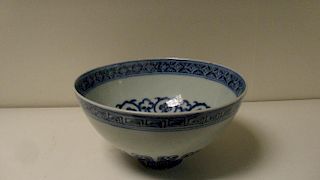 A Ming style blue and white bowl, decorated in the Yongzheng taste with a cash medallion rim band on
