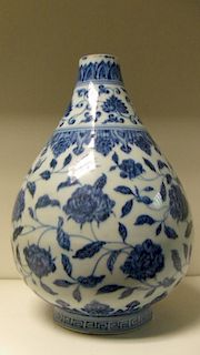 A Ming style blue and white vase, the onion shape painted with scrolling lotus between leaf lappets,
