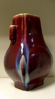A flambe arrow vase of rectangular sectioned baluster shape, the broader sides of the body with rais
