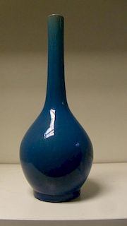 An early 20th century turquoise bottle vase, the glaze paler at the rim of the slender neck than at