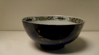An 18th century famille verte bowl, the powder blue exterior gilt with flowers opposite an inscripti