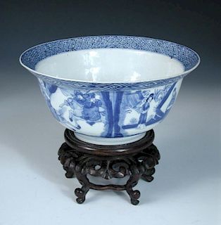 A blue and white bowl, six character mark and period of Kangxi, with hardwood stand, the flared rim