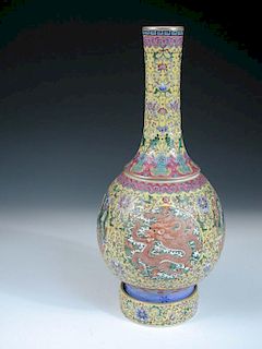 A Qianlong style bottle vase rotatable on its stand, painted with lappet bands enclosing the scrolli