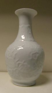 A Republic period white glazed bottle vase, moulded with lappets on the neck and with a dragon chasi