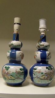 A pair of late 19th/early 20th century famille verte double gourd vases, the triple lobed bodies pai