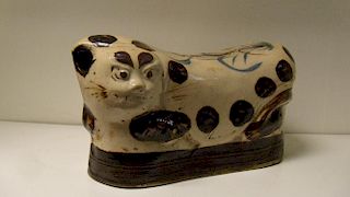 A Cizhou pillow modelled in the form of a leopard reclining on a black cushion, its back inscribed t