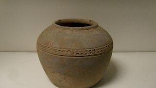 An archaic style grey pottery jar, the rim above rounded shoulders ending a wheel impressed band and