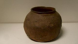 A Shang dynasty red pottery jar, the sides flaring to broad rounded shoulders impressed with a diamo