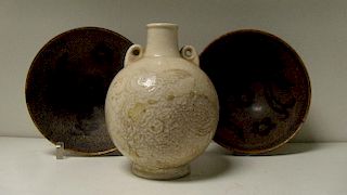 A pair of Song brown glazed bowls and a tingyao vase, the interiors with alternating birds and flowe