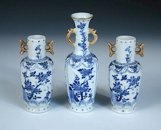 A garniture of three blue and white vases, period of Kangxi, each of the shallow moulded panels on t