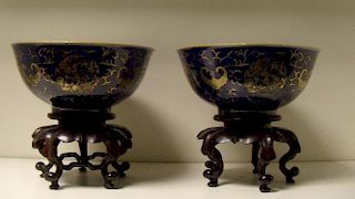 A pair of gilt powder blue ground bowls, seal marks of Qianlong, the exteriors with alternating bats