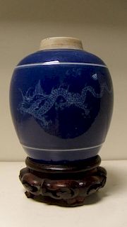 A late 18th/early 19th century white on blue jar with wood stand, white ribs raised horizontally on