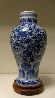 An 18th century blue and white baluster vase, the shoulders painted with lappet panels of flowers ab