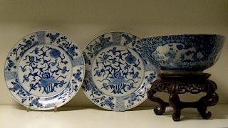 A pair of blue and white plates, period of Kangxi, and a later bowl, the plates painted with central