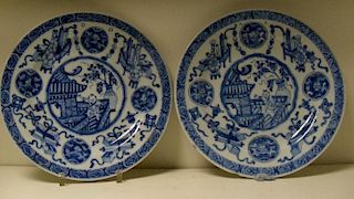 A pair of blue and white plates, period of Kangxi, each centrally painted with a boy waving from a r