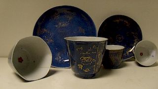 Two pairs of 18th century powder blue ground tea bowls and two saucers, each tea bowl with a red che