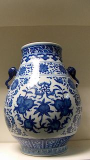 A Ming style blue and white vase bearing Qianlong seal mark, the body decorated with peaches and goo
