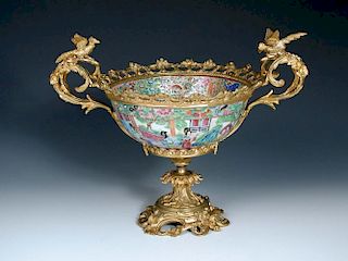 An ormolu mounted Canton bowl, the bowl typically painted with panels of families alternating with g