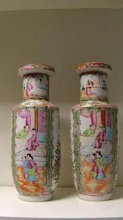 A pair of 19th century Canton vases, the necks, rims and shoulders forming reel shapes above the rou