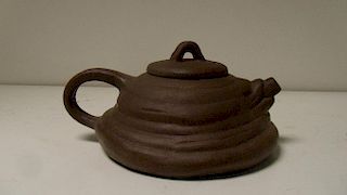 A Yixing tea pot and cover, the bell shape modelled as a coil of ropes, seal marks, 10.5cm (4 in) di