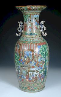A 19th century Canton celadon ground vase, the neck with two dragon handles above a court scene pain