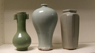 Three celadon vases, the oldest possibly Ming, the meiping shape under a pale green glaze, 24cm (9.5