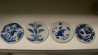 A boxed set of four Ming blue and white 'coasters', each cut and shaped from the foot of a bowl or v