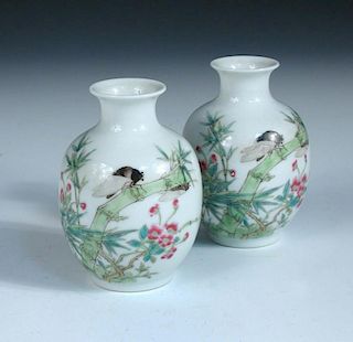 A pair of Republic period vases, each painted with two insects on a stem of bamboo amongst flowers,