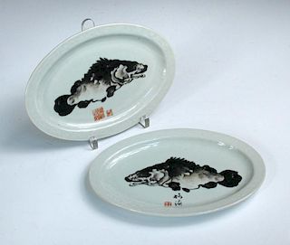 Wang Bu (1896-1968), two oval dishes each decorated with fish inside rims moulded with flowering vin