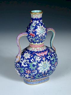 A blue ground two handled vase, seal mark of Jiaqing, the flattened gourd shape painted with scrolli