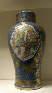 A 19th century blue ground famille verte vase, the baluster shape painted with figures inside moulde