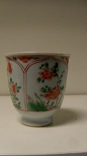 An 18th century famille verte beaker cup, the exterior painted with iron red lotus petal framed pane