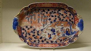 A late 19th century Fukugawa Imari tray, the rounded rectangular gallery with blue trefoil handles,