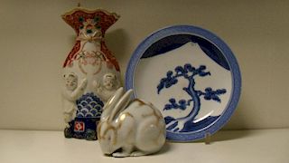 An Arita blue and white plate, a Kutani rabbit and and Imari wall pocket, the plate painted with a p