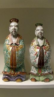 A pair of early 20th century Kutani temple figures, the two similar dignitaries standing with their