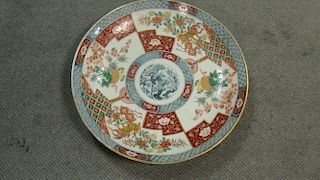 A late 19th/early 20th century Imari dish, the central blue roundel of prunus, pine and bamboo enclo